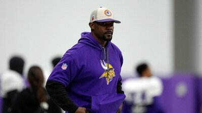 Minnesota Vikings defensive coordinator Brian Flores stands on the field during an NFL football workout in Eagan (AP)