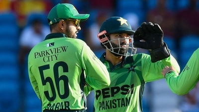 (L/R) Babar Azam and Mohammad Rizwan of Pakistan celebrate the dismissal of Shai Hope of West Indies during the second One Day International (ODI) cricket match between West Indies and Pakistan (AFP)