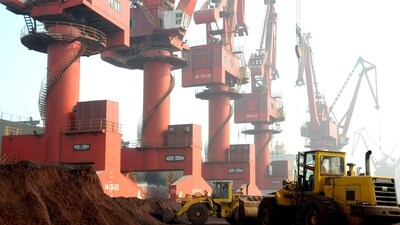 FILE PHOTO: Workers transport soil containing rare earth elements for export at a port in Lianyungang, Jiangsu province, China (REUTERS )