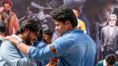 Some fans even brought along custom-made Coolie tags to ape Rajinikanth's tag in the Lokesh Kanagaraj film. (PTI) Some fans even brought along custom-made Coolie tags to ape Rajinikanth's tag in the Lokesh Kanagaraj film. (PTI)