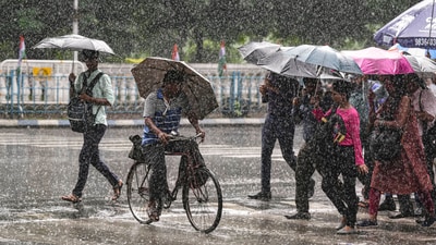 Pedestrians weren't spared either, battling slippery, broken pavements and muddy walkways. (PTI) Pedestrians weren't spared either, battling slippery, broken pavements and muddy walkways. (PTI)