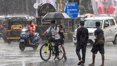 Commuters using umbrellas during rain in Mumbai, Maharashtra (PTI) Commuters using umbrellas during rain in Mumbai, Maharashtra (PTI)