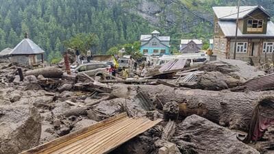 People move through the debris after a massive cloudburst at Chishoti village, in Jammu and Kashmir's Kishtwar district, Thursday, Aug. 14 (PTI) People move through the debris after a massive cloudburst at Chishoti village, in Jammu and Kashmir's Kishtwar district, Thursday, Aug. 14 (PTI)