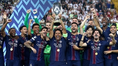 Paris Saint Germain's Marquinhos lifts the trophy as he celebrates with teammates after winning the UEFA Super Cup (REUTERS)