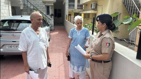 Cyber police sensitising elderly residents during a door-to-door awareness drive on digital arrest frauds in Chandigarh on Thursday. (HT Photo)