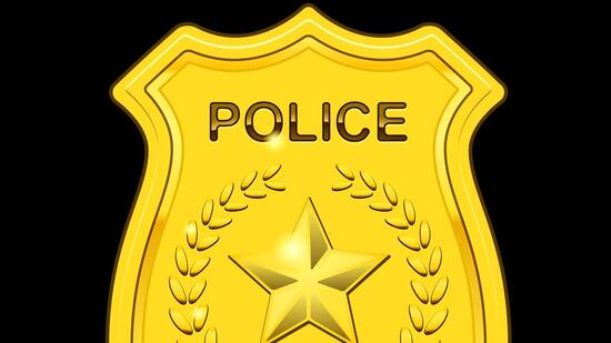 Gold Police Badge isolated on black background