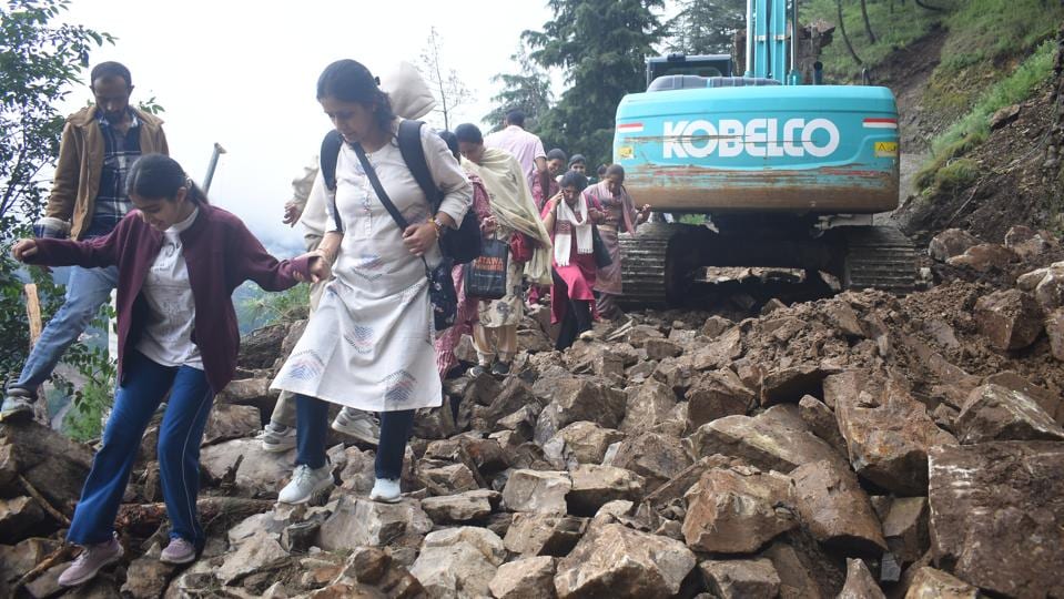 People making their way over the debris after a landslide on Chamyana road near Bhattakufer in Shimla on Thursday. (Deepak Sansta/HT) People making their way over the debris after a landslide on Chamyana road near Bhattakufer in Shimla on Thursday. (Deepak Sansta/HT)