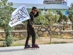 A Taliban security personnel skates along a street during a rally marking the fourth anniversary of the Taliban takeover of Afghanistan in Ghazni on August 15, 2025. A Taliban security personnel skates along a street during a rally marking the fourth anniversary of the Taliban takeover of Afghanistan in Ghazni on August 15, 2025.
