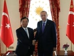 Turkish President Recep Tayyip Erdogan (right) shakes hands with Wang Chuanfu, chairman and CEO of China's BYD, during a meeting in Istanbul