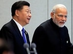 China's President Xi Jinping and India's Prime Minister Narendra Modi arrive for a signing ceremony during Shanghai Cooperation Organization (SCO) summit in Qingdao, Shandong Province, China June 10, 2018. 