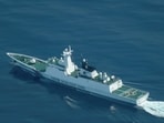 An aerial view of a China Coast Guard ship navigating near the disputed Scarborough Shoal, as Philippine Coast Guard aircraft carrying journalists patrol the area.