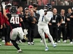 Tennessee Titans quarterback Cameron Ward (1) throws a pass over Atlanta Falcons linebacker JD Bertrand (40) Tennessee Titans quarterback Cameron Ward (1) throws a pass over Atlanta Falcons linebacker JD Bertrand (40)