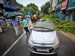A damaged car seen as a massive tree falls on busy road amid heavy rains at Kalkaji in New Delhi. A damaged car seen as a massive tree falls on busy road amid heavy rains at Kalkaji in New Delhi.