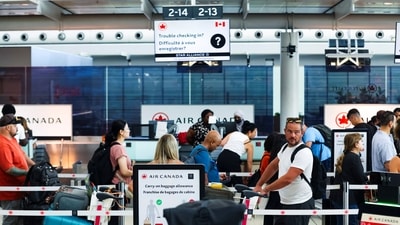 Passengers wait at an Air Canada check-in counter, ahead of a potential strike by flight attendants of the airline, at the Toronto Pearson International Airport in Mississauga, Ontario, Canada, August 15, 2025. (Reuters)