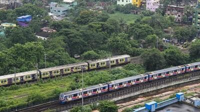 Kolkata: A metro train and an Eastern Railways local train cross each other, in Kolkata (PTI FILE PHOTO)