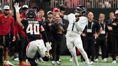 Tennessee Titans quarterback Cameron Ward (1) throws a pass over Atlanta Falcons linebacker JD Bertrand (40) (AP) Tennessee Titans quarterback Cameron Ward (1) throws a pass over Atlanta Falcons linebacker JD Bertrand (40) (AP)