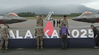 The carpeting is lined on either side with fighter jets, parked at an angle. (X) The carpeting is lined on either side with fighter jets, parked at an angle. (X)