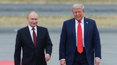 Russian President Vladimir Putin and US President Donald Trump walk on the tarmac (via REUTERS)