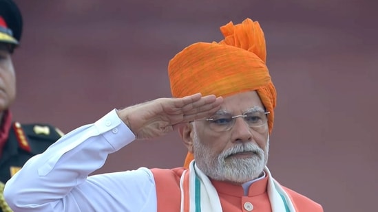 Prime Minister Narendra Modi stands for the national anthem after hoisting the national flag during the 79th Independence Day celebration at the Red Fort, in New Delhi. (PMO)