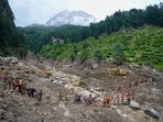 Stranded pilgrims are helped across a water channel using a makeshift bridge a day after flash floods in Chishoti village, Kishtwar district. Stranded pilgrims are helped across a water channel using a makeshift bridge a day after flash floods in Chishoti village, Kishtwar district.