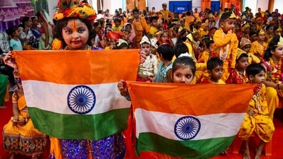 Students dressed as Lord Krishna and Radha during celebrations of Independence Day and Janmashtami festival at a school, in Prayagraj on Thursday. (PTI)
