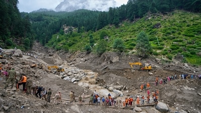 Stranded pilgrims are helped across a water channel using a makeshift bridge a day after flash floods in Chishoti village, Kishtwar district. (AP ) Stranded pilgrims are helped across a water channel using a makeshift bridge a day after flash floods in Chishoti village, Kishtwar district. (AP )