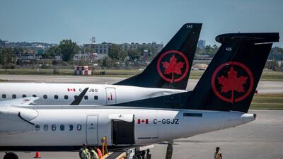 Two Air Canada planes are seen on the tarmac of the Pierre-Elliott Trudeau Airport in Montreal, Quebec, Canada, on Friday. (AFP) Two Air Canada planes are seen on the tarmac of the Pierre-Elliott Trudeau Airport in Montreal, Quebec, Canada, on Friday. (AFP)