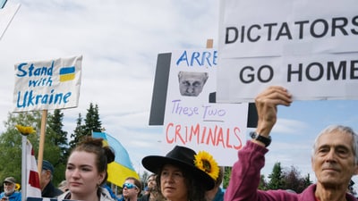Demonstrators showing support for Ukraine at Delaney Park Strip in downtown Anchorage.