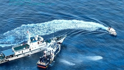 A China Coast Guard ship uses a water cannon against a Philippine Bureau of Fisheries and Aquatic Resources ship in the South China Sea, May 22. A China Coast Guard ship uses a water cannon against a Philippine Bureau of Fisheries and Aquatic Resources ship in the South China Sea, May 22.