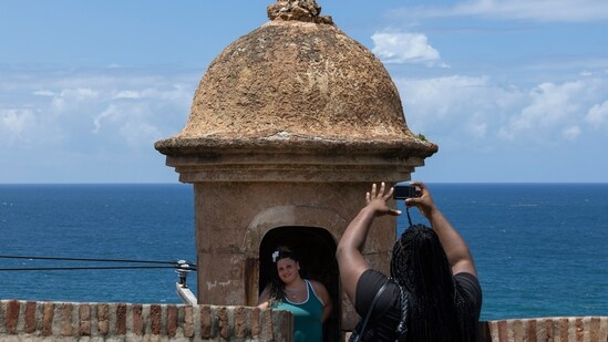 Hurricane Erin: A tourist poses for a photo inside a sentry box overlooking the ocean near the La Perla neighborhood in Old San Juan, Puerto Rico, as Hurricane Erin approaches, Friday, Aug. 15, 2025. (AP Photo/Alejandro Granadillo) (AP)