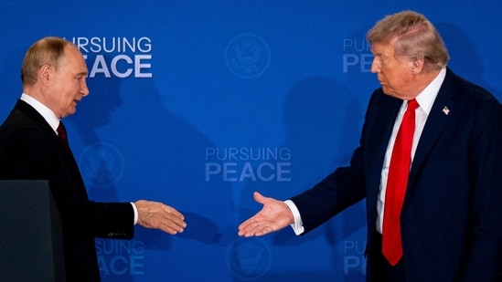 Russia's President Vladimir Putin and US President Donald Trump reach out to shake hands during a joint news conference at Joint Base Elmendorf-Richardson in Anchorage, Alaska, US, on Friday. (Bloomberg)