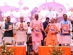 UP CM Yogi Adityanath releasing dy CM Brajesh Pathak’s book on former PM Atal Bihari Vajpayee in Lucknow. (HT photo)