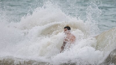 A man is hit by rough waves at a beach as Category 5 Hurricane Erin approaches in San Juan, Puerto Rico, on August 16, 2025. &nbsp;(Photo by Ricardo ARDUENGO / AFP) (AFP)