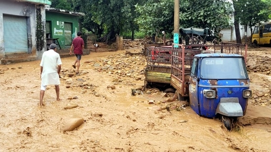 People make their way through debris and mud accumulated in a residential area following a cloudburst, in Kathua, Sunday, Aug. 17, 2025. People make their way through debris and mud accumulated in a residential area following a cloudburst, in Kathua, Sunday, Aug. 17, 2025.