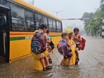 Mumbai policemen rescued school children from a bus caught in flood waters at Kings Circle and brought them to Matunga police station Mumbai policemen rescued school children from a bus caught in flood waters at Kings Circle and brought them to Matunga police station