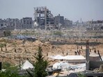 Displaced Palestinians make their way towards the site of a humanitarian aid airdrop at the Bureij camp in the central Gaza Strip, 