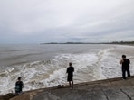 People fish along the shore in Arecibo, Puerto Rico, as Hurricane Erin brings rains to the island, Sunday, Aug. 17, 2025. (AP Photo/Alejandro Granadillo)