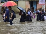 School children make their way through water logged on Tilak Rd, near Khodadad Cricle at Dadar TT, in Mumbai. (Anshuman Poyrekar/ Hindustan Times)
