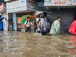 Mumbai rain: People wade through a waterlogged road after heavy rain, at King Circle, Mumbai on Monday.