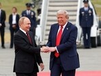 US President Donald Trump shakes hand with Russian President Vladimir Putin