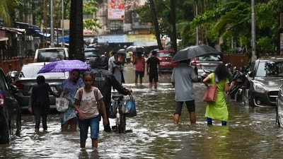 Commuters wade through knee deep water in a waterlogged street in Mumbai on Saturday after heavy rains continue to drench the city. (Raju Shinde/Hindustan Times) Commuters wade through knee deep water in a waterlogged street in Mumbai on Saturday after heavy rains continue to drench the city. (Raju Shinde/Hindustan Times)