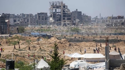 Displaced Palestinians make their way towards the site of a humanitarian aid airdrop at the Bureij camp in the central Gaza Strip, (AFP) Displaced Palestinians make their way towards the site of a humanitarian aid airdrop at the Bureij camp in the central Gaza Strip, (AFP)