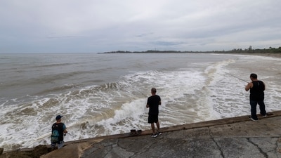 People fish along the shore in Arecibo, Puerto Rico, as Hurricane Erin brings rains to the island, Sunday, Aug. 17, 2025. (AP Photo/Alejandro Granadillo) (AP) People fish along the shore in Arecibo, Puerto Rico, as Hurricane Erin brings rains to the island, Sunday, Aug. 17, 2025. (AP Photo/Alejandro Granadillo) (AP)