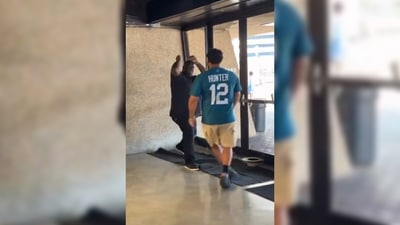 In the video, a Jaguars fan in a Travis Hunter jersey can be seen fighting the Saints fan, who is in a black tee-shirt. (X/@NFL_DovKleiman) In the video, a Jaguars fan in a Travis Hunter jersey can be seen fighting the Saints fan, who is in a black tee-shirt. (X/@NFL_DovKleiman)
