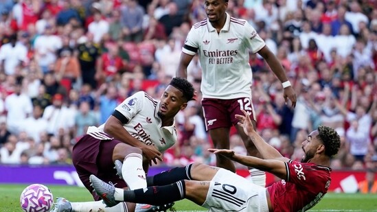 Arsenal's William Saliba, left, challenges Manchester United's Matheus Cunha. (AP)