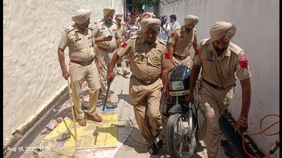 Police seize a bike during the cordon and search operation at Bangala Basti in Kharar on Monday. (HT)