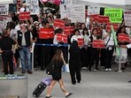 Striking Air Canada flight attendants hold placards as they defy a back to work order at Vancouver International Airport in Richmond, British Columbia, Canada