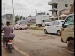 The video, shared by a resident, captures vehicles struggling to navigate deep potholes and uneven surfaces.