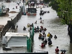 Mumbai rains: Commuters, buses seen at a waterlogged street in Kurla west. A red alert has been sounded for Mumbai, Thane, Raigad and more as heavy rains lash over parts of Maharashtra.