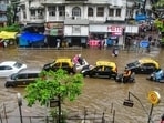 Mumbai rains: Commuters wade through a waterlogged road in Dadar TT area